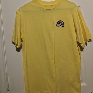 a yellow shirt with a rainbow on the side